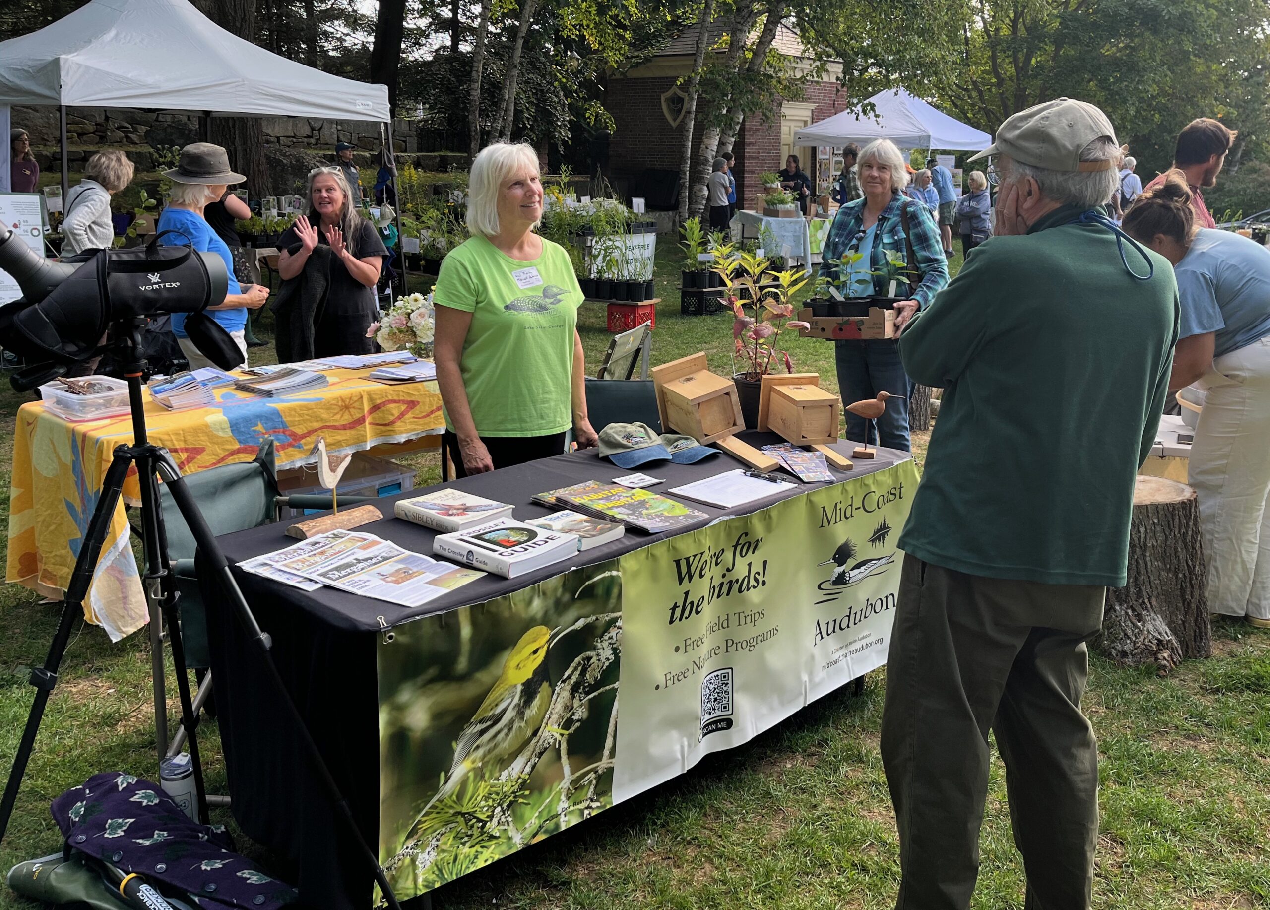 Volunteer standing at information table
